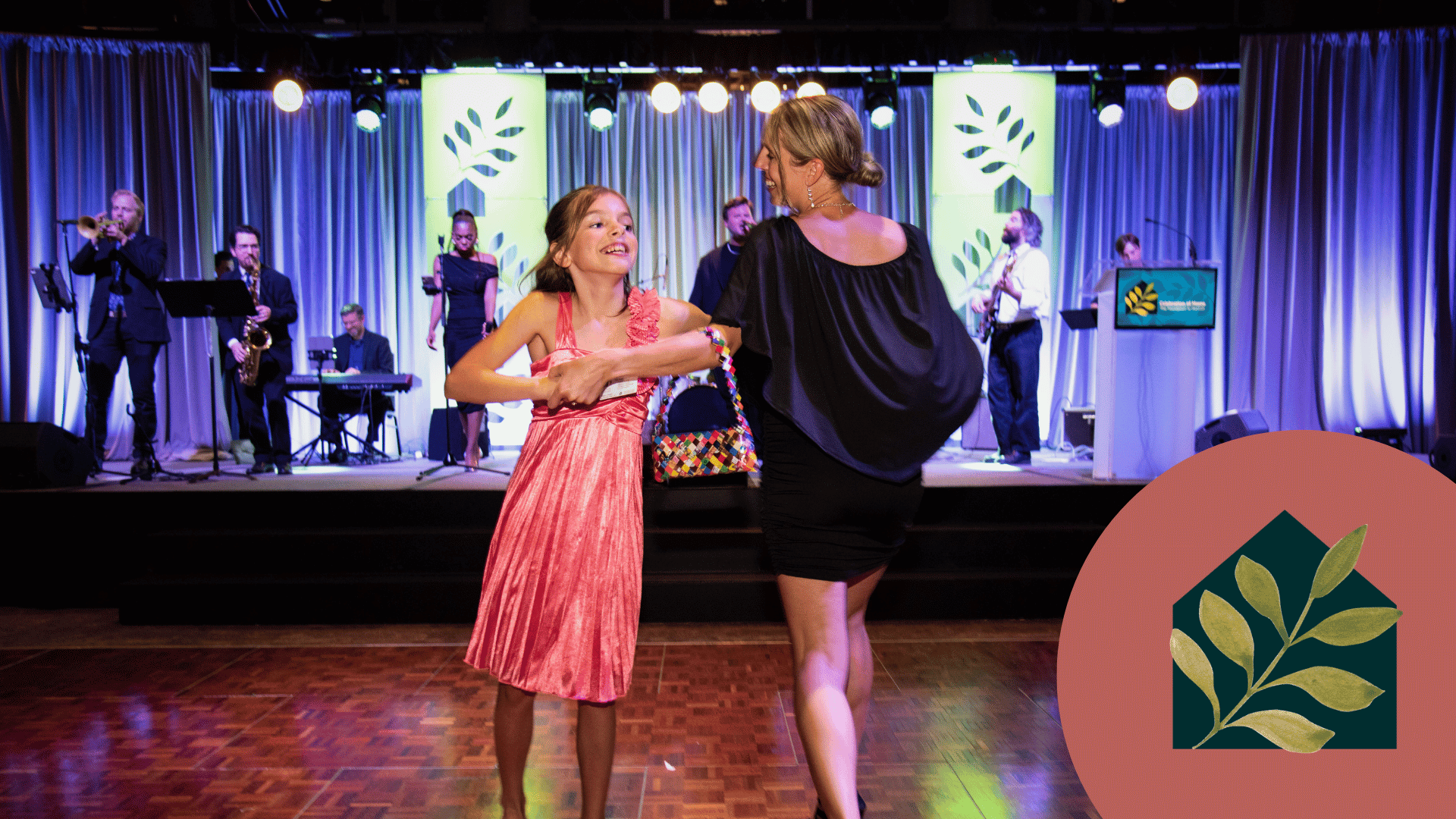 Mom and daughter dancing to live band